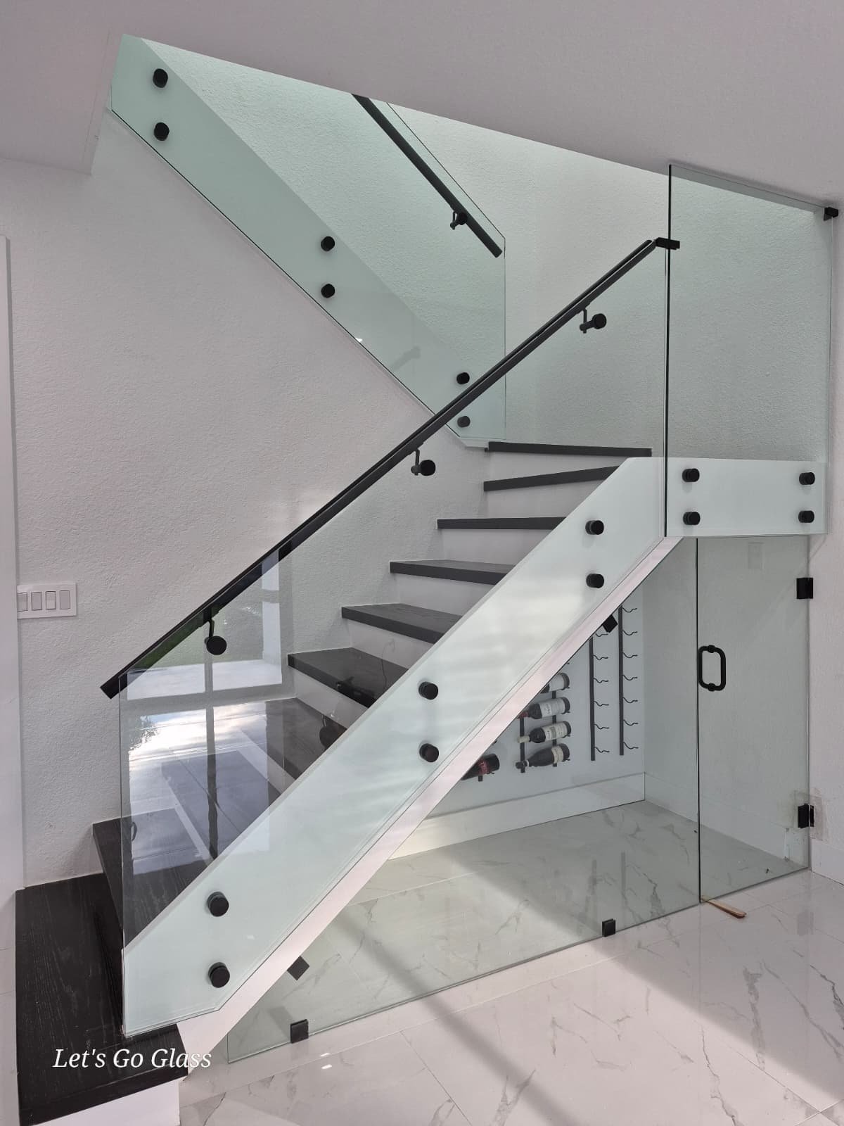 Frameless glass shower door with brushed gold hardware, Miami