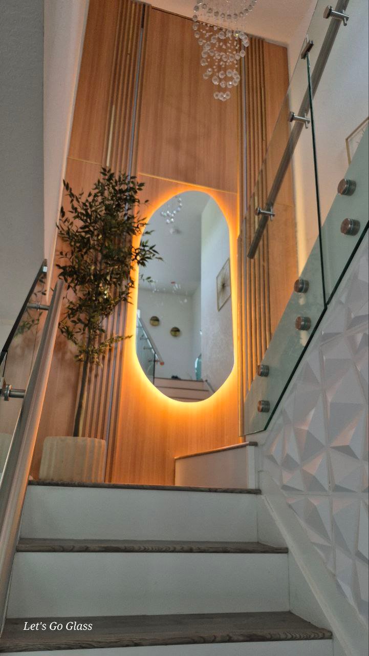 Custom backlit oval mirror installation